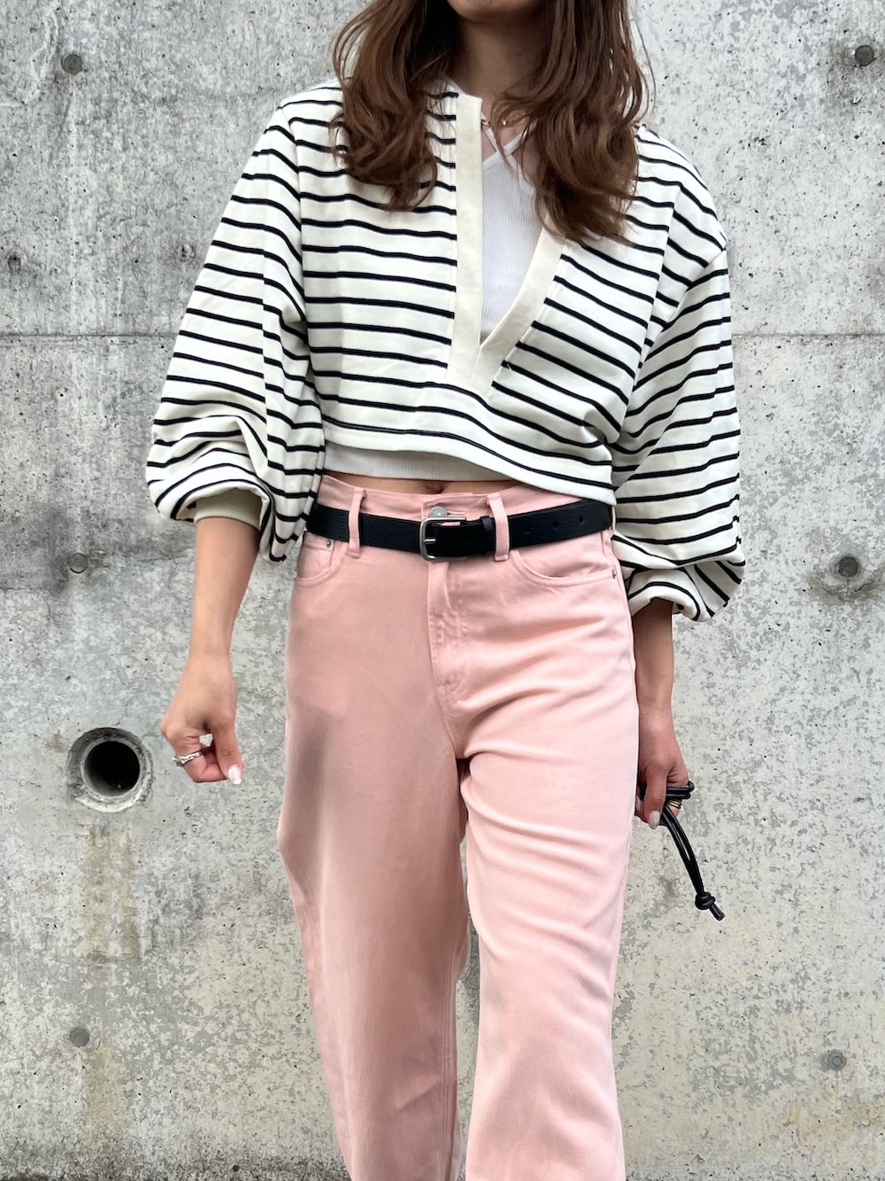 ホワイト系のスウェット、ピンク系のパンツ、レッド系のショルダーバッグを着用したレディースの春コーディネートの2枚目の写真