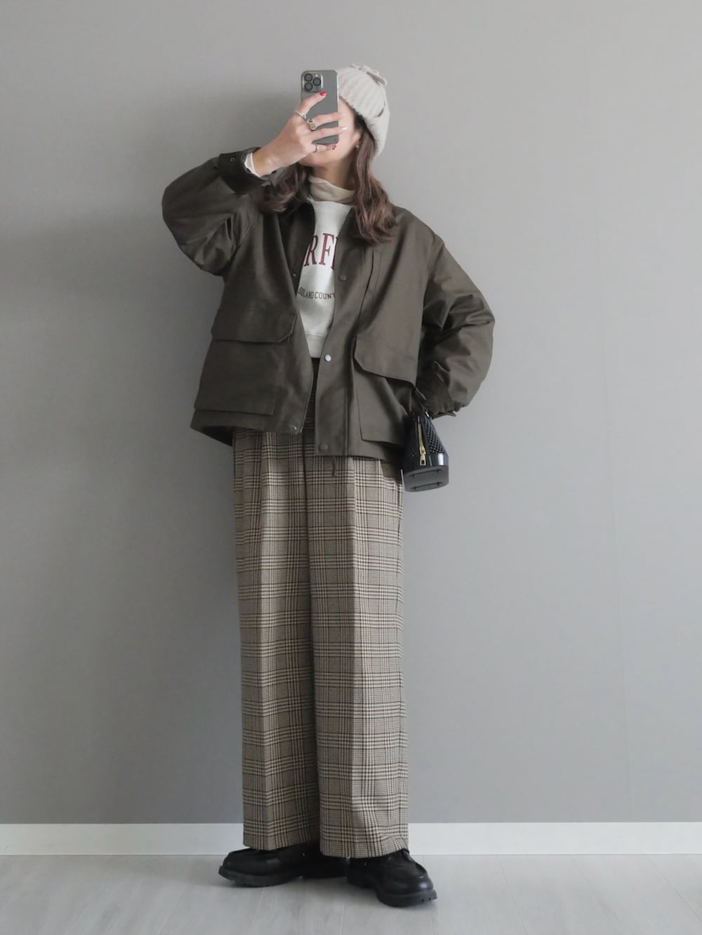 グレー系のスウェット、ベージュ系のパンツ、グリーン系のジャケット/アウターを着用したレディースの冬コーディネートの4枚目の写真