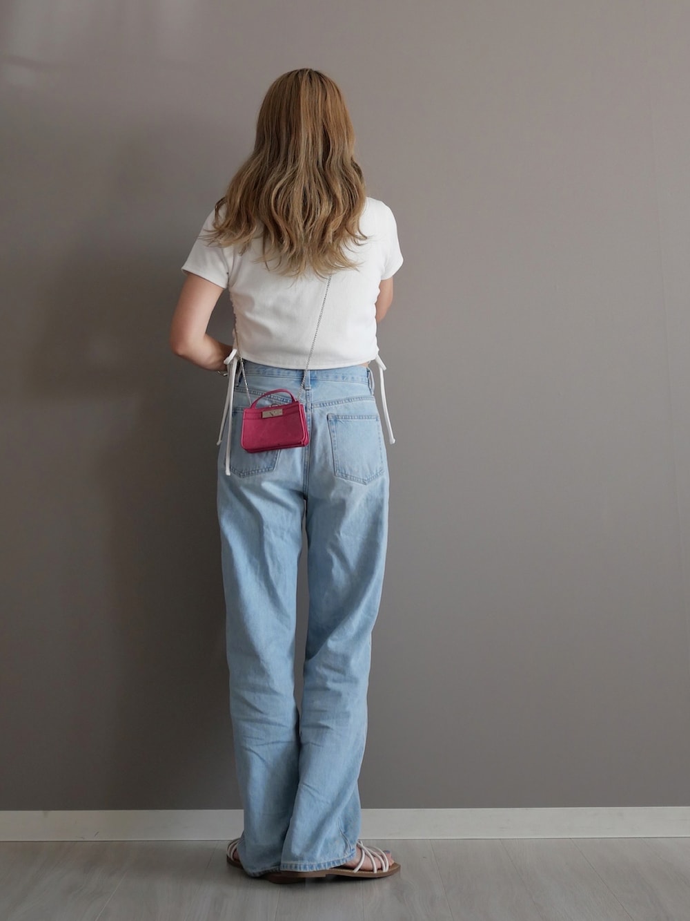 ホワイト系のTシャツ/カットソー、グレー系のデニムパンツ、ピンク系のショルダーバッグを着用したレディースの夏コーディネートの4枚目の写真