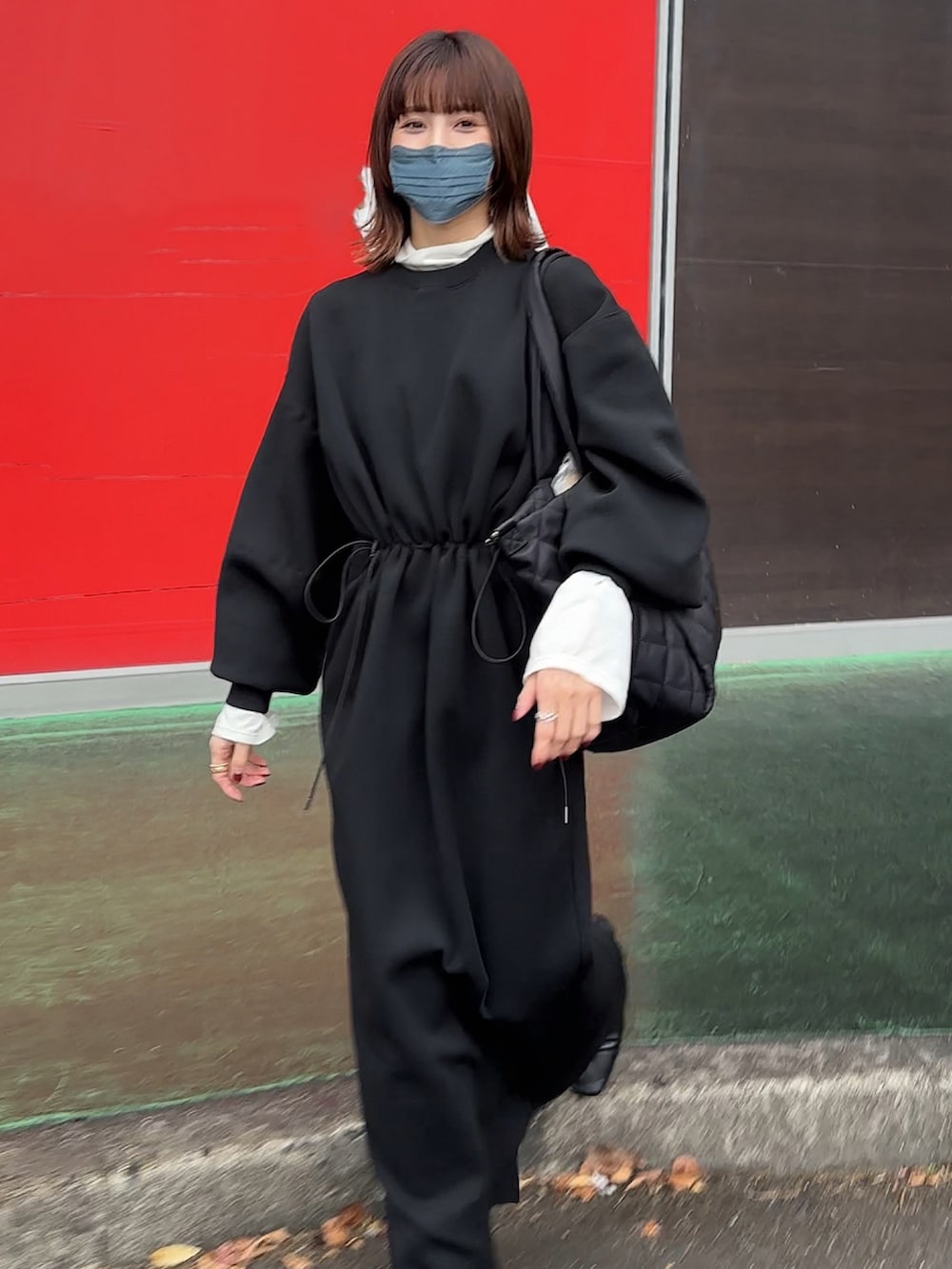 ブラック系のワンピース、ブラック系のマザーズバッグを着用したレディースの冬コーディネートの2枚目の写真