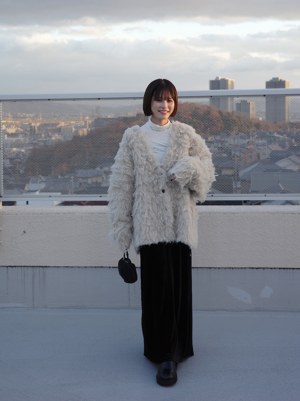 ホワイト系のカーディガン/ボレロを着用したレディースの冬コーディネートの2枚目の写真