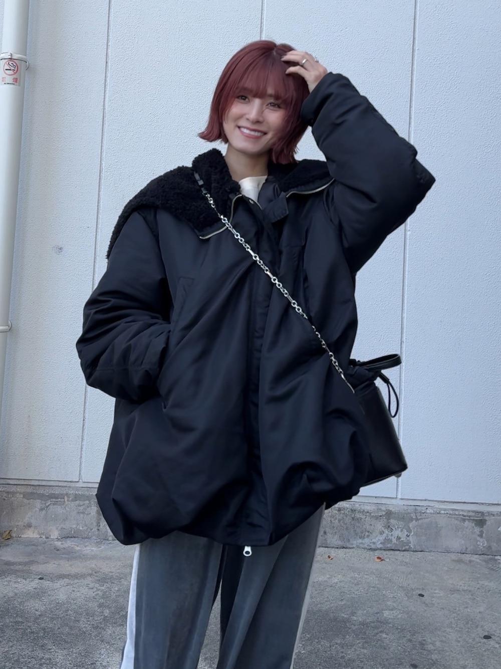 ホワイト系のスウェット、グレー系のその他パンツ、ブラック系のブーツを着用したレディースの冬コーディネートの2枚目の写真