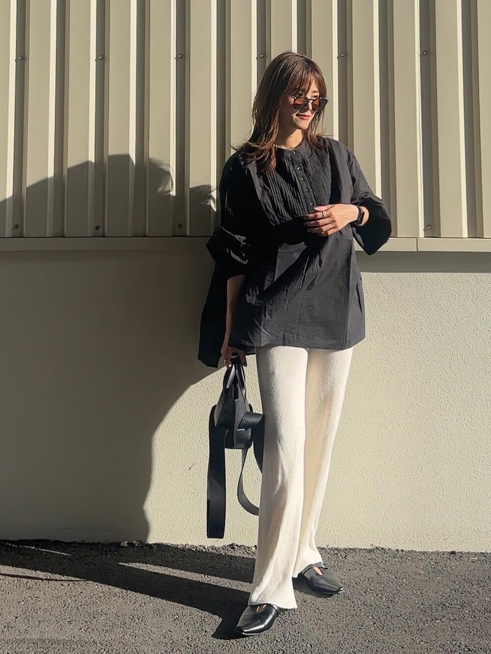 ブラック系のシャツ/ブラウス、ブラック系のパンプスを着用したレディースの秋コーディネートの4枚目の写真