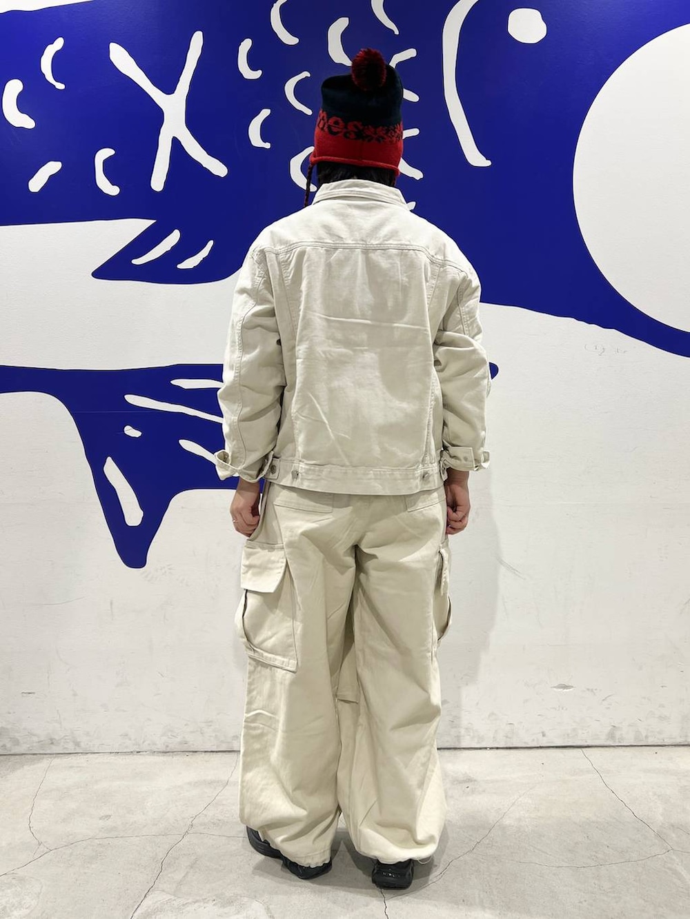 ベージュ系のブルゾン、ベージュ系のカーゴパンツ、ブラック系のニットキャップ/ビーニーを着用したレディースの冬コーディネートの7枚目の写真