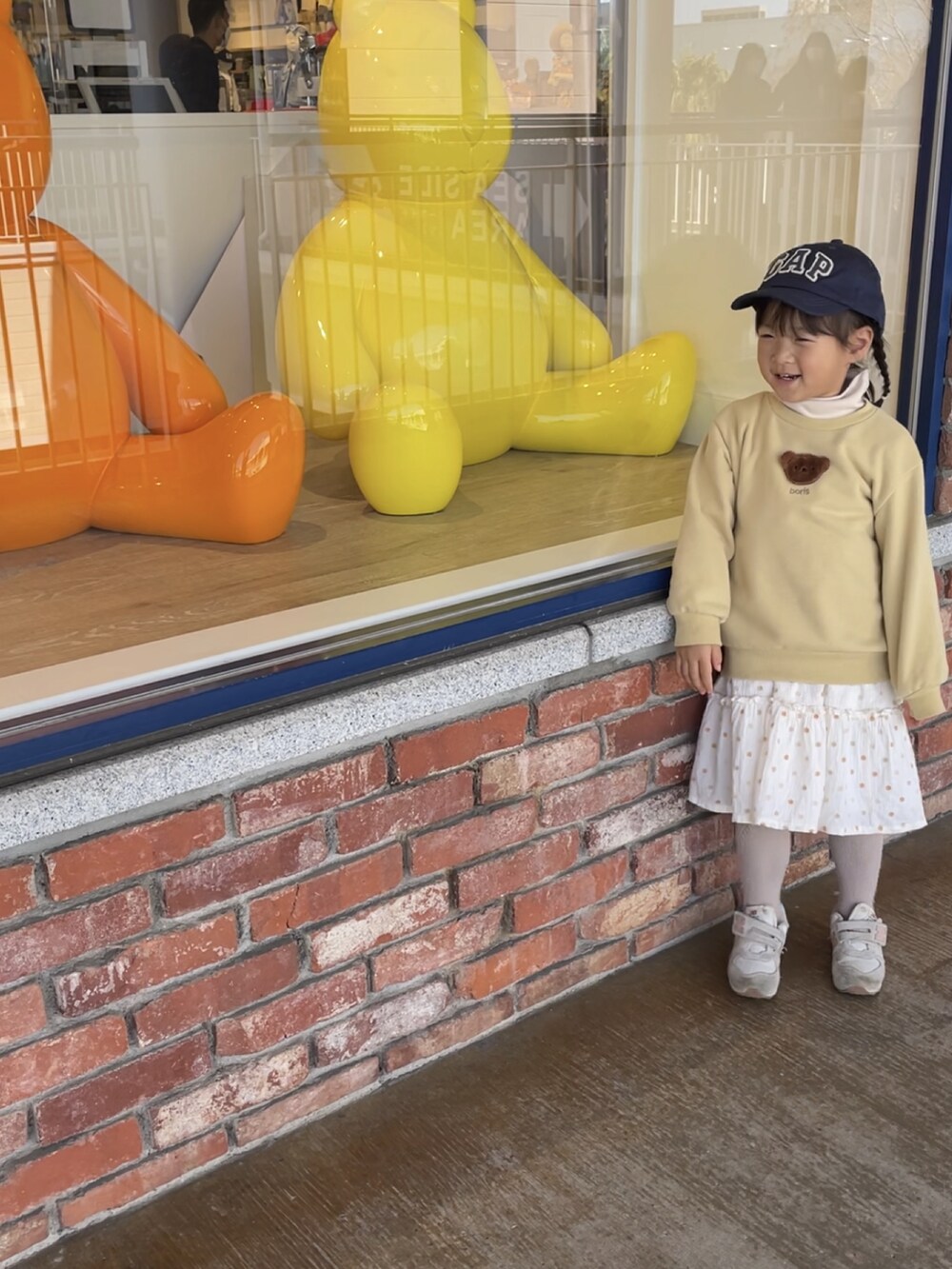 イエロー系のトップスを着用したレディースの春コーディネートの2枚目の写真