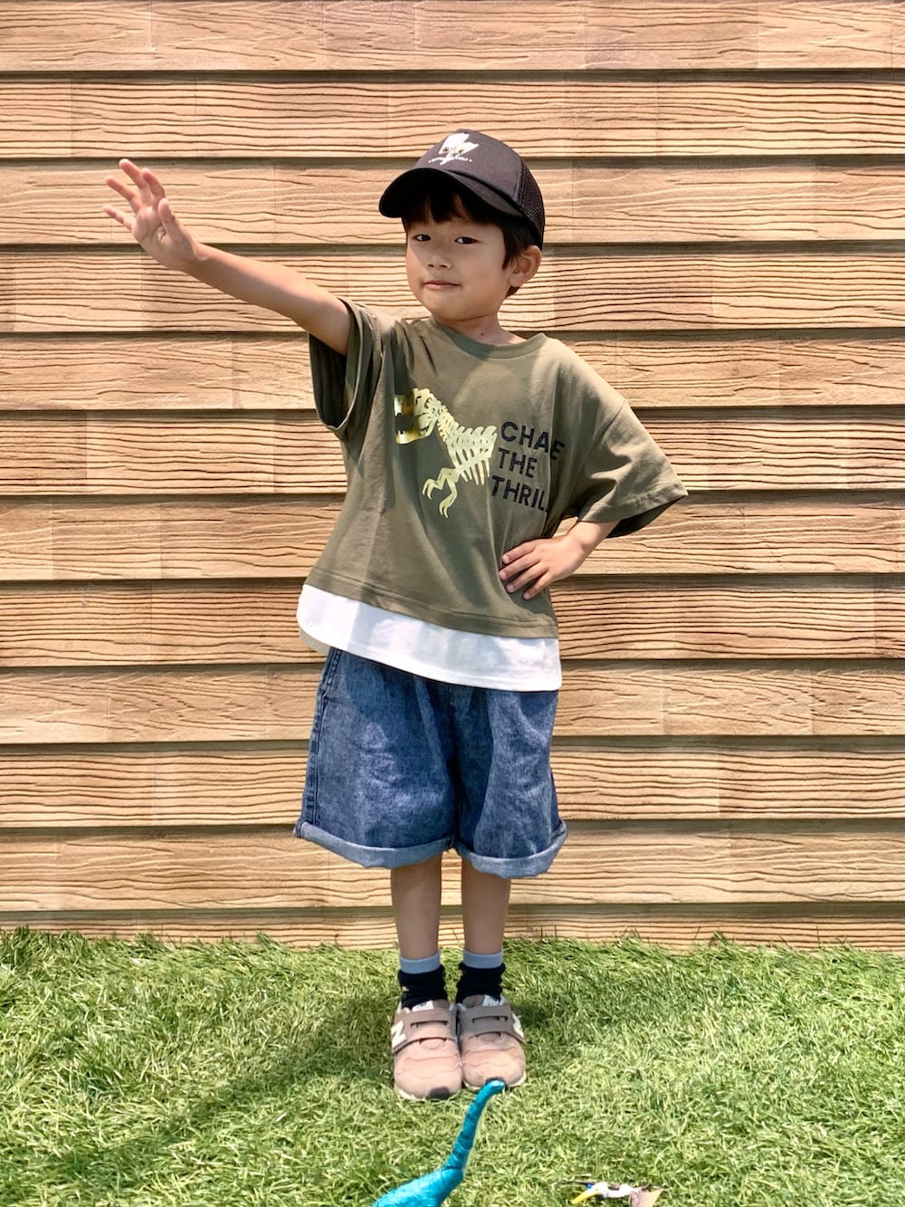 グリーン系のTシャツ/カットソー、ブルー系のその他パンツ、ブラック系のキャップを着用したキッズの秋コーディネートの2枚目の写真