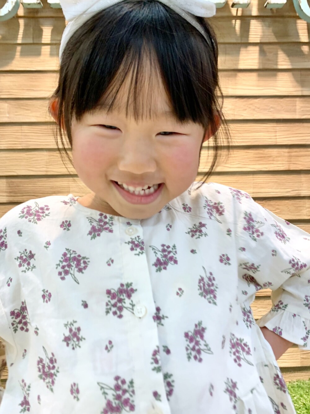 ベージュ系のワンピース、ブラウン系のその他パンツ、グリーン系のラッピングキットを着用したキッズの春コーディネートの5枚目の写真