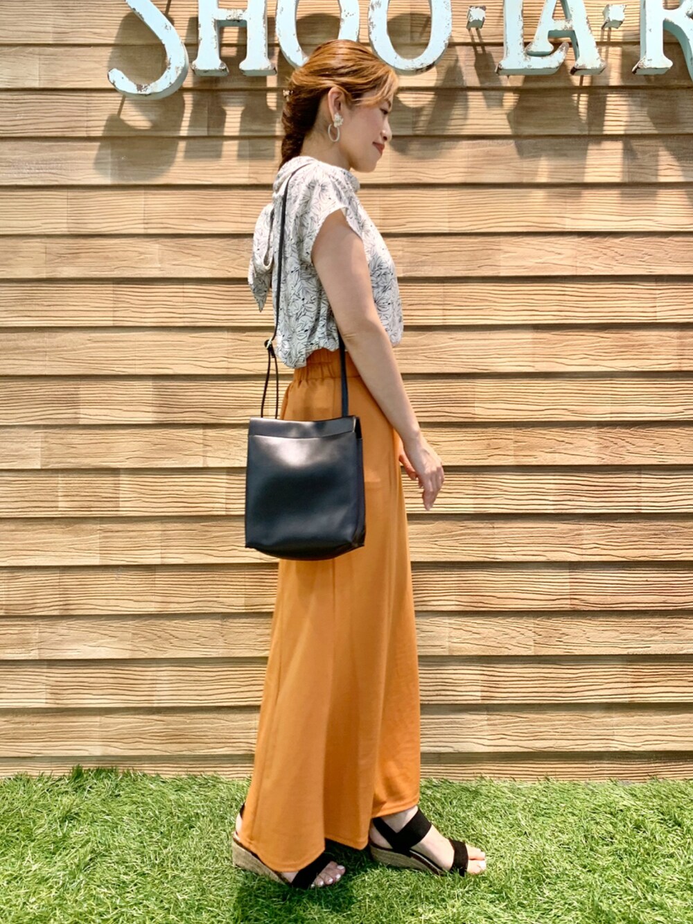 ホワイト系のシャツ/ブラウス、オレンジ系のスカート、ブラック系のショルダーバッグを着用したレディースの秋コーディネートの4枚目の写真