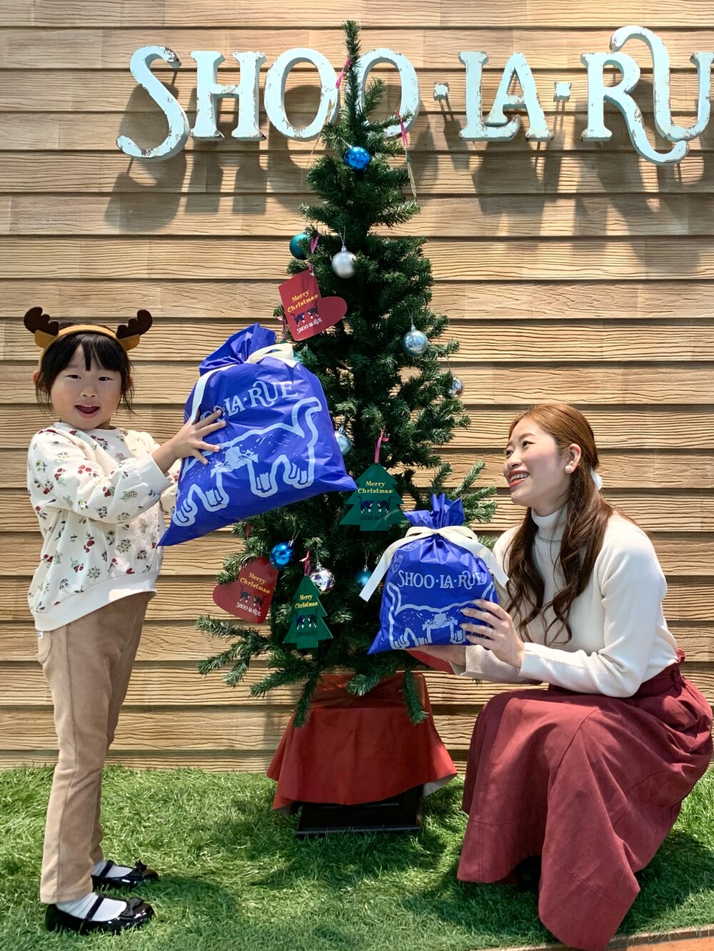 ホワイト系のニット/セーター、レッド系のスカート、ホワイト系のブーツを着用したレディースの冬コーディネートの4枚目の写真