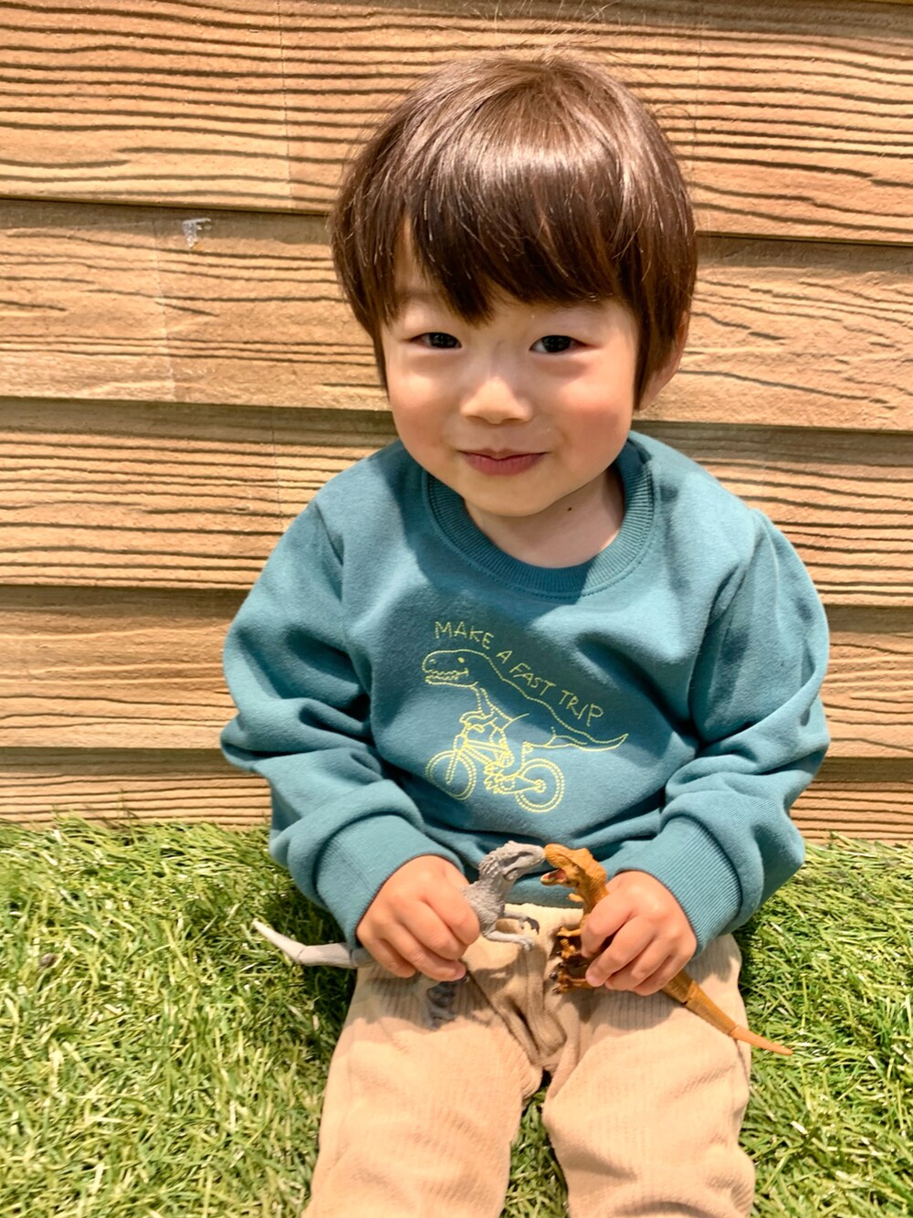 グリーン系のスウェット、ベージュ系のパンツ、ホワイト系のその他を着用したキッズの冬コーディネートの5枚目の写真