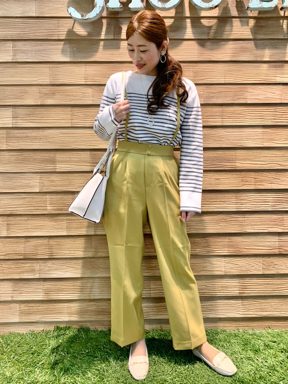 グレー系のニット/セーター、イエロー系のその他パンツ、ホワイト系のトートバッグを着用したレディースの冬コーディネートの2枚目の写真