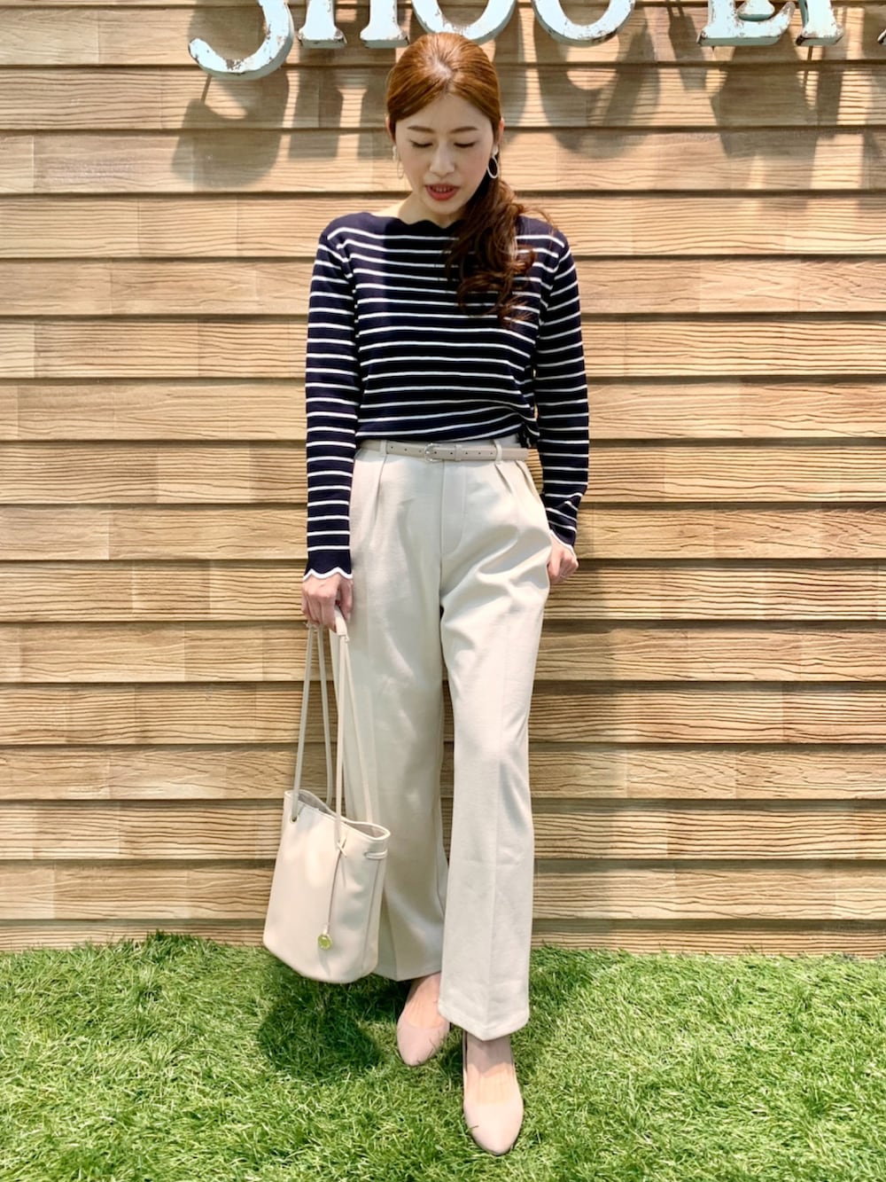 ブルー系のニット/セーター、ホワイト系のその他パンツ、ホワイト系のトートバッグを着用したレディースの春コーディネートの3枚目の写真