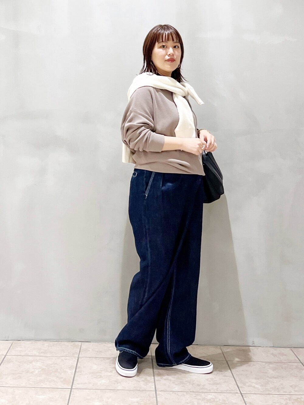 グレー系のTシャツ/カットソー、ホワイト系のカーディガン/ボレロ、ブラック系のトートバッグを着用したレディースの秋コーディネートの2枚目の写真