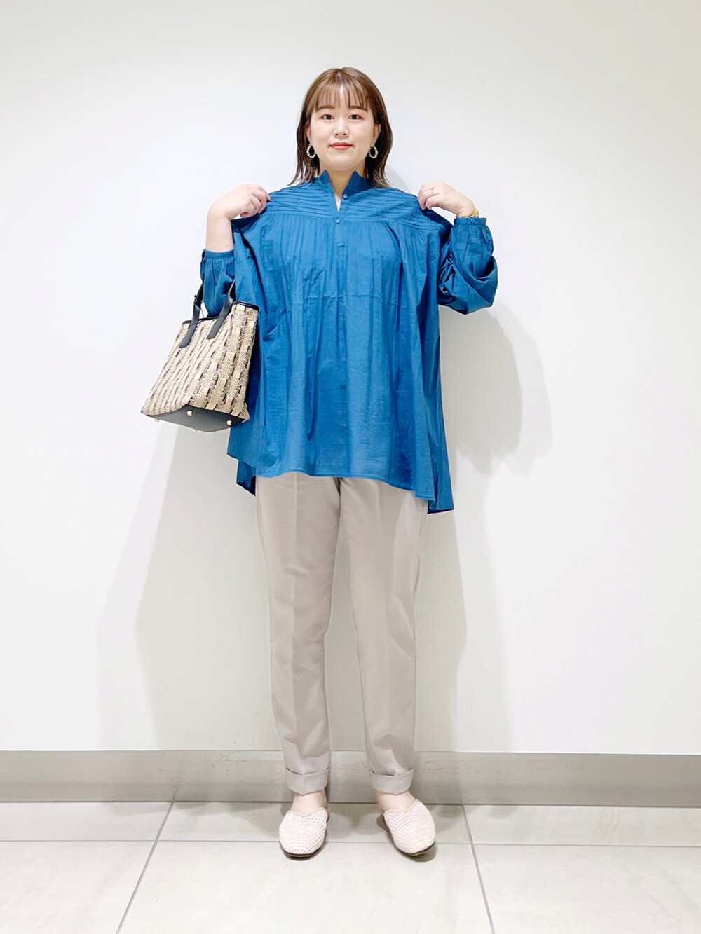 ブルー系のシャツ/ブラウス、ブラック系のショルダーバッグ、ベージュ系のその他パンツを着用したレディースの春コーディネートの4枚目の写真