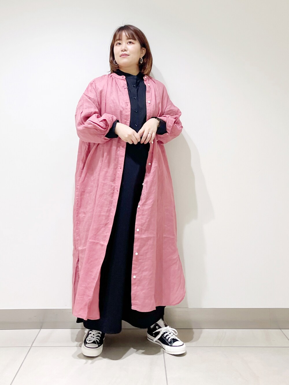 ブラック系のワンピース、ピンク系のワンピース、ブラック系のスニーカーを着用したレディースの春コーディネートの5枚目の写真