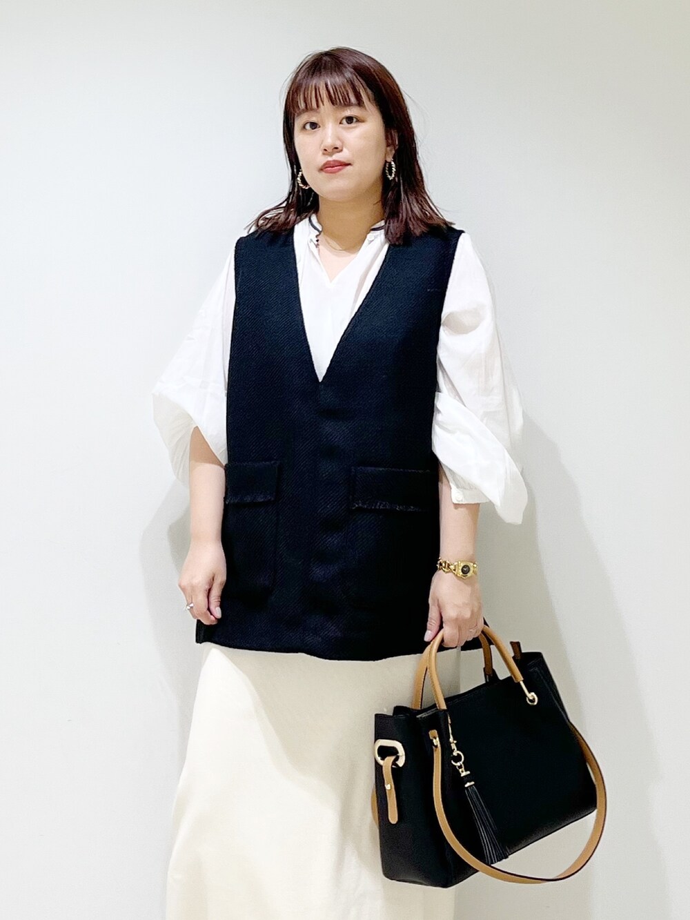 ブラック系のトップス、ホワイト系のシャツ/ブラウス、その他のスカートを着用したレディースの秋コーディネートの5枚目の写真