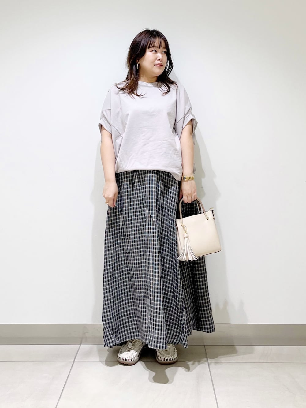 グレー系のTシャツ/カットソー、その他のスカート、ホワイト系のトートバッグを着用したレディースの春コーディネートの2枚目の写真