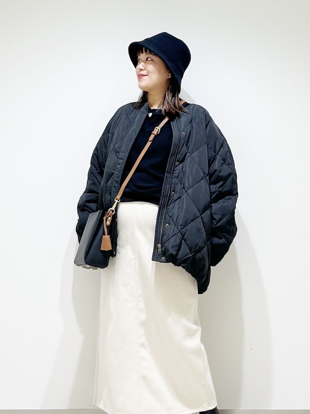 ブラック系のTシャツ/カットソー、ブラック系のその他アウター、ホワイト系のスカートを着用したレディースの秋コーディネートの3枚目の写真