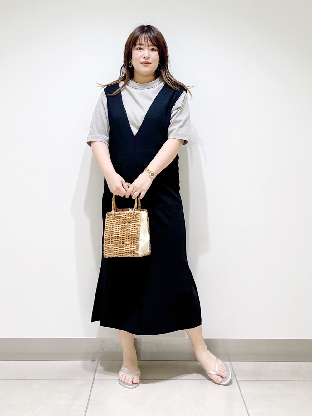 ブラック系のワンピース、グレー系のTシャツ/カットソー、ベージュ系のハンドバッグを着用したレディースの夏コーディネートの3枚目の写真