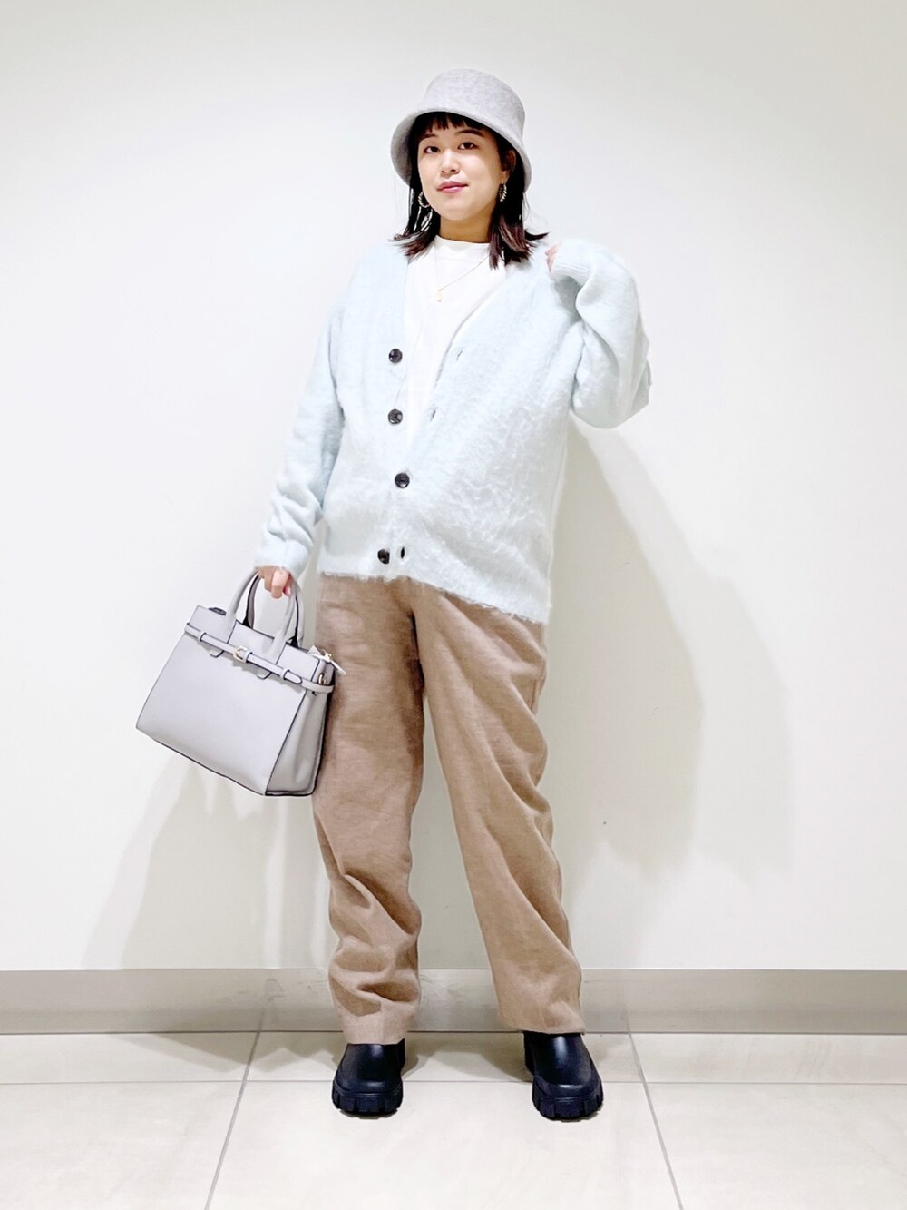 グリーン系のカーディガン/ボレロ、ベージュ系のその他パンツ、ブラック系のブーツを着用したレディースの秋コーディネートの8枚目の写真