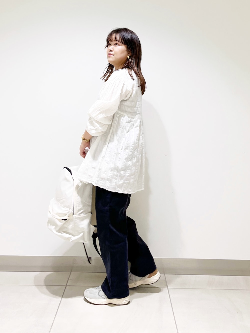 ホワイト系のシャツ/ブラウス、ブルー系のその他パンツ、ホワイト系のバックパック/リュックを着用したレディースの春コーディネートの3枚目の写真