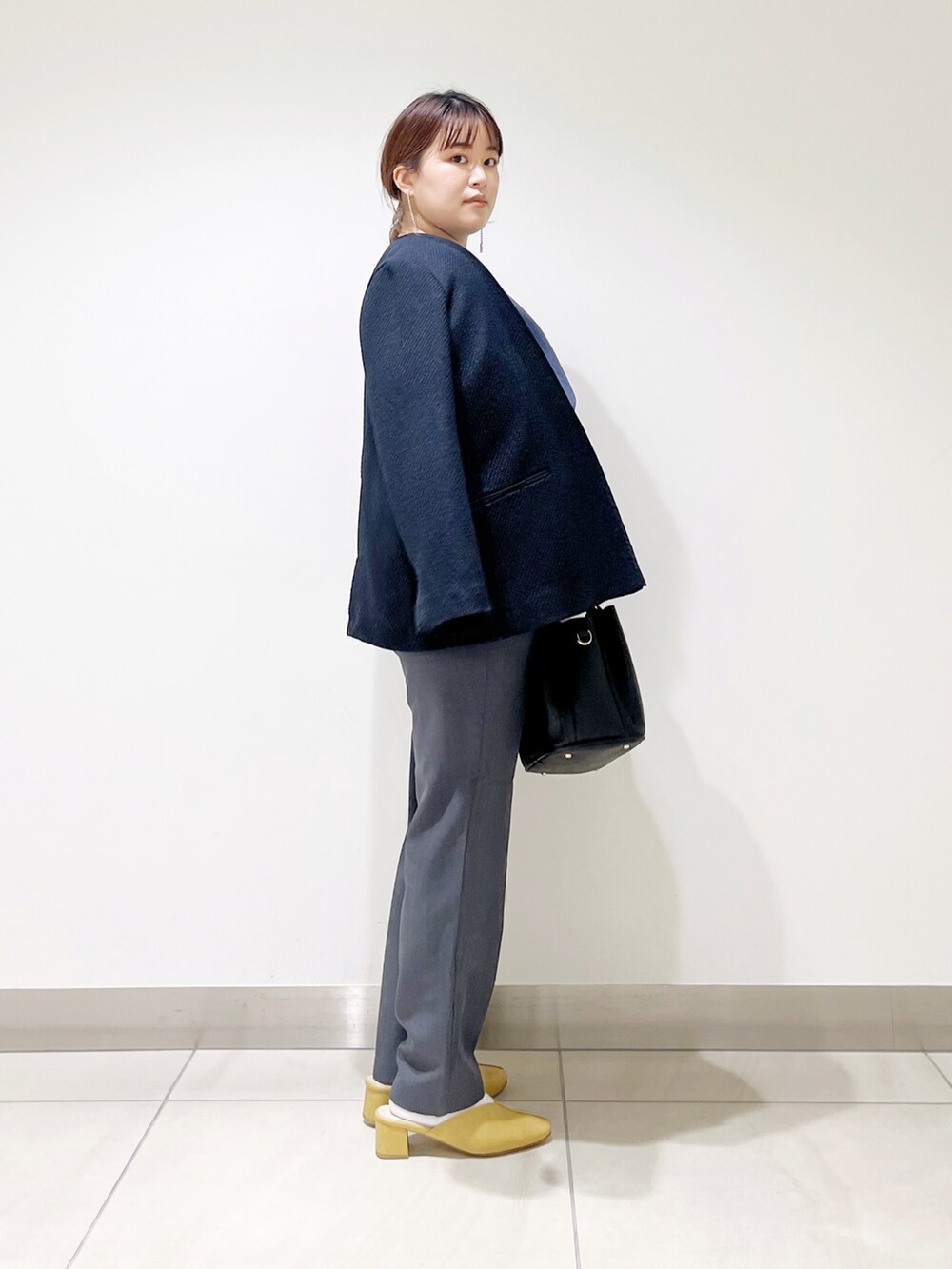 ブルー系のシャツ/ブラウス、ブルー系のスーツジャケット、ブラック系のトートバッグを着用したレディースの春コーディネートの2枚目の写真
