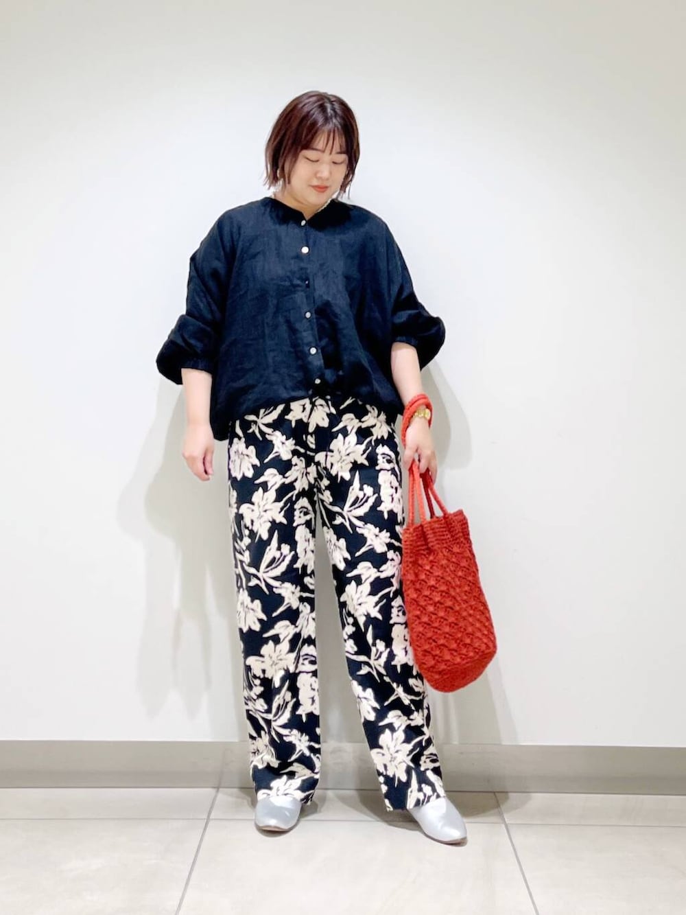 シルバー系のパンプス、ブラック系のその他パンツ、オレンジ系のトートバッグを着用したレディースの春コーディネートの8枚目の写真