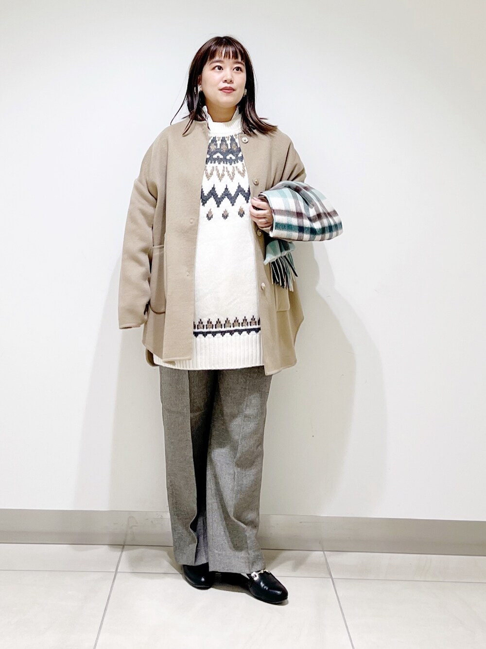 ベージュ系のノーカラージャケット、ホワイト系のニット/セーター、グレー系のその他パンツを着用したレディースの秋コーディネートの3枚目の写真