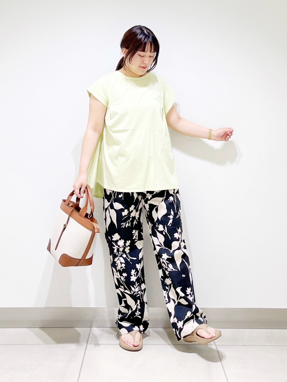グリーン系のTシャツ/カットソー、ブラック系のその他パンツ、ブラウン系のバッグを着用したレディースの夏コーディネートの5枚目の写真