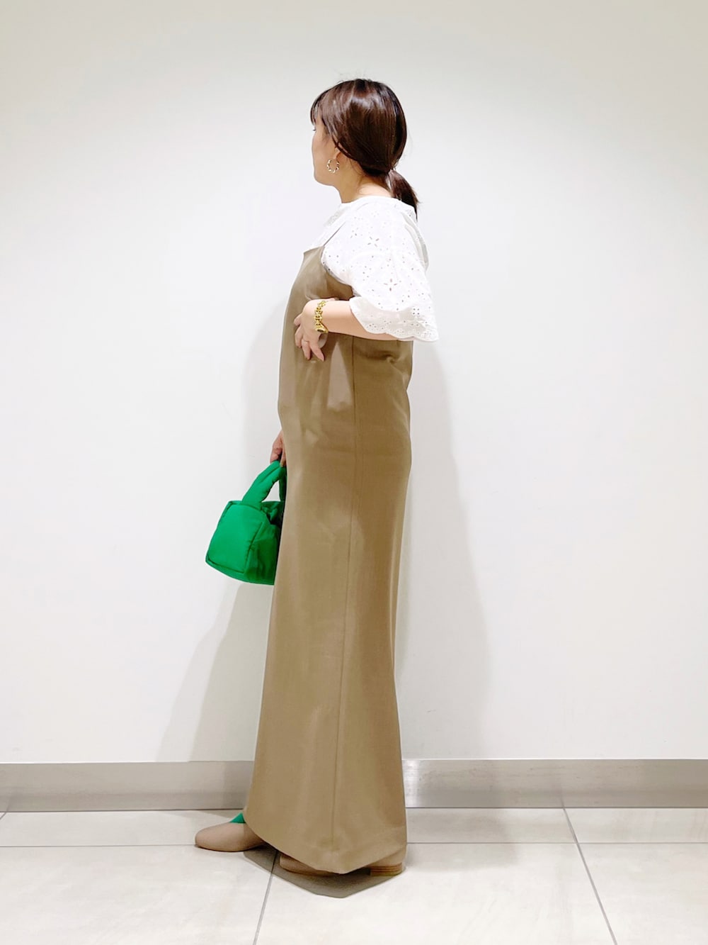 ホワイト系のシャツ/ブラウス、ブラウン系のワンピース、グリーン系のハンドバッグを着用したレディースの秋コーディネートの4枚目の写真