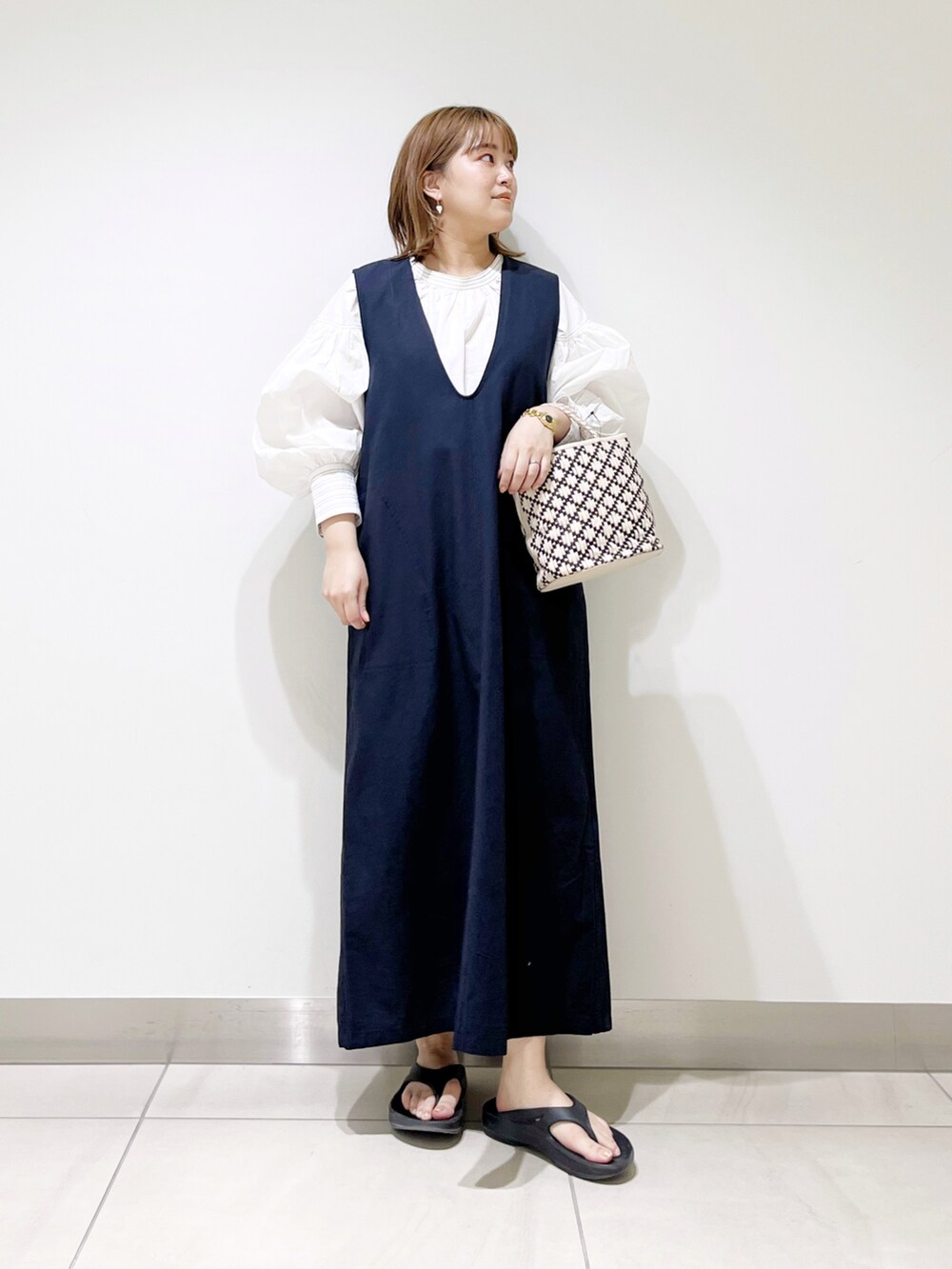 ホワイト系のTシャツ/カットソー、ホワイト系のハンドバッグ、ブルー系のワンピースを着用したレディースの春コーディネートの2枚目の写真