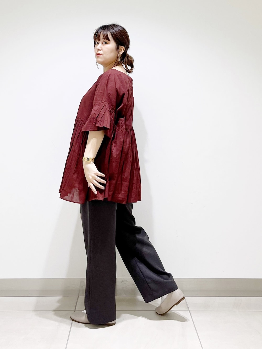 レッド系のシャツ/ブラウス、グレー系のその他パンツ、ベージュ系のトートバッグを着用したレディースの夏コーディネートの3枚目の写真
