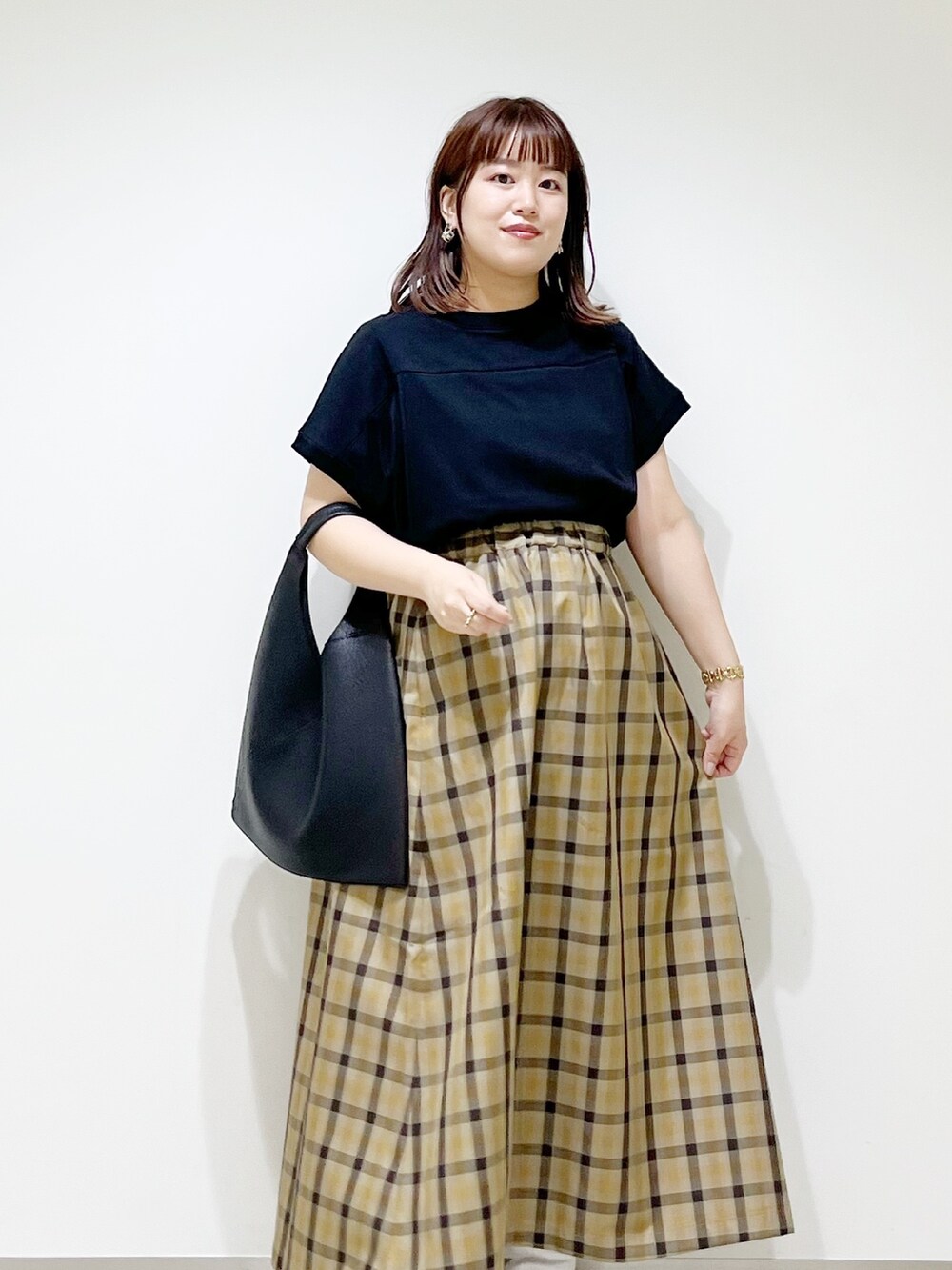 ホワイト系のスニーカー、ブラック系のTシャツ/カットソー、ブラック系のトートバッグを着用したレディースの秋コーディネートの4枚目の写真