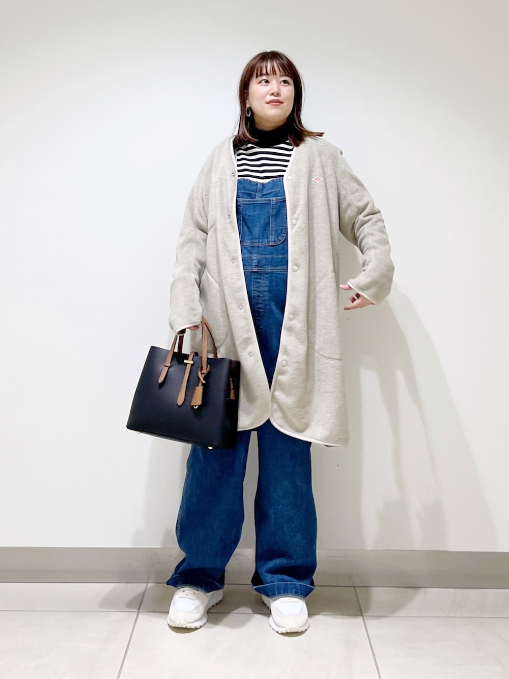 ブルー系のサロペット/オーバーオール、ベージュ系のジャケット/アウター、ブラック系のトップスを着用したレディースの秋コーディネートの4枚目の写真