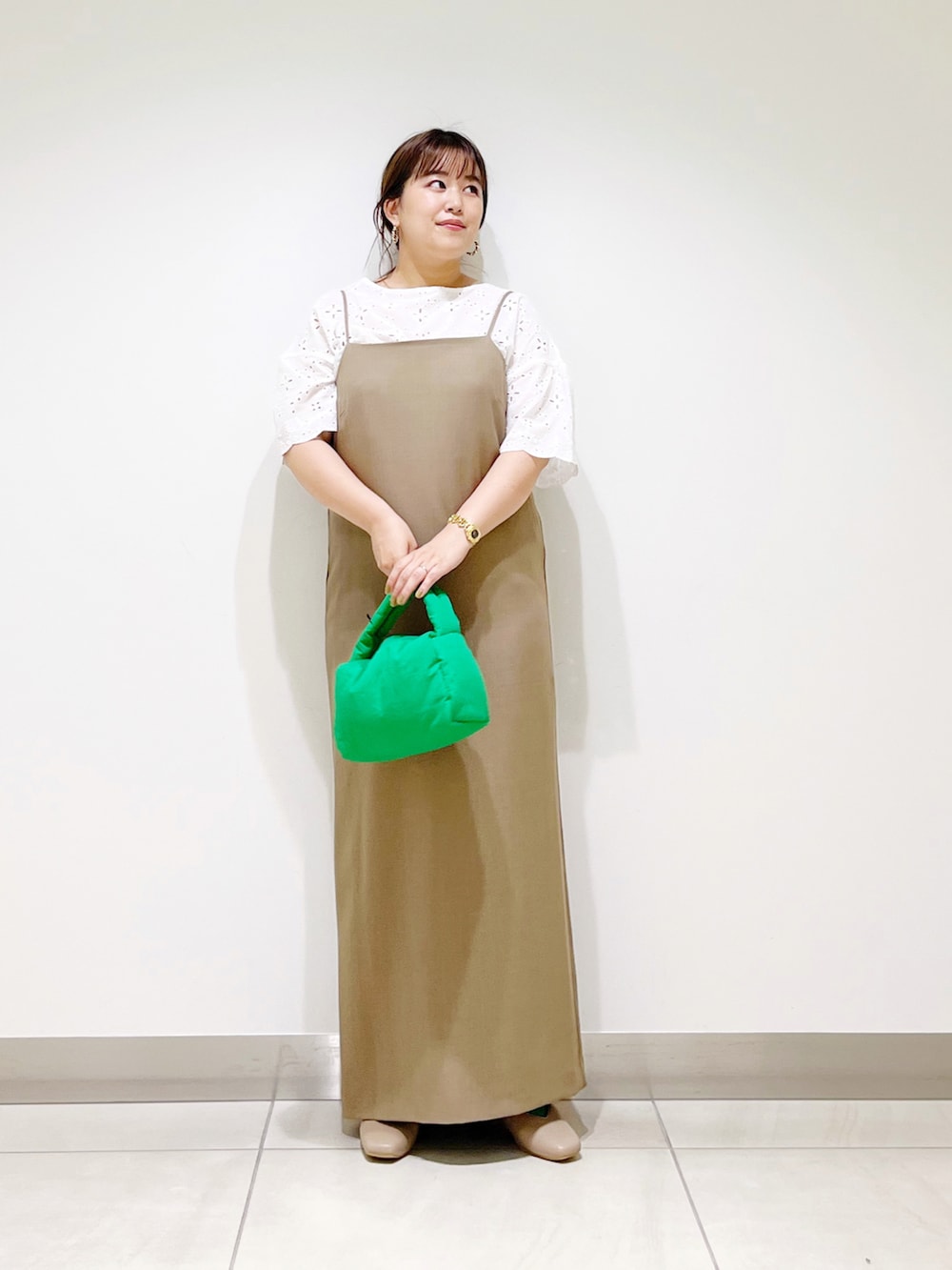 ホワイト系のシャツ/ブラウス、ブラウン系のワンピース、グリーン系のハンドバッグを着用したレディースの秋コーディネートの2枚目の写真