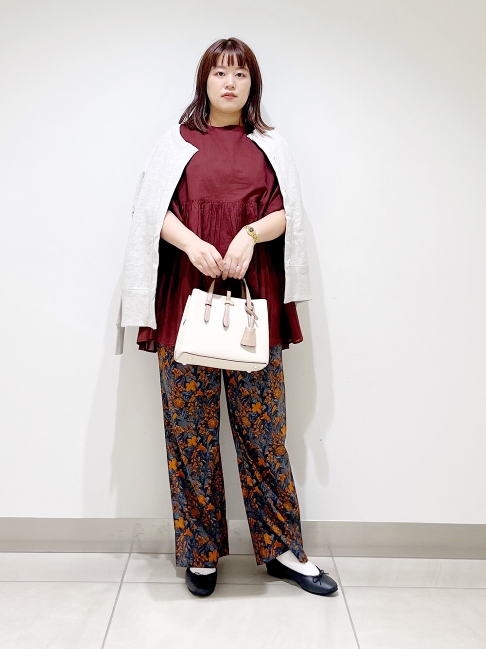 オレンジ系のその他パンツ、レッド系のシャツ/ブラウス、グレー系のカーディガン/ボレロを着用したレディースの秋コーディネートの5枚目の写真