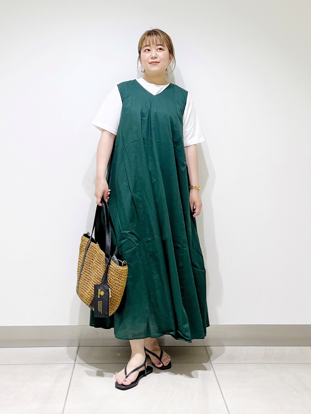 グリーン系のワンピース、イエロー系のトートバッグ、ブラック系のサンダルを着用したレディースの夏コーディネートの5枚目の写真
