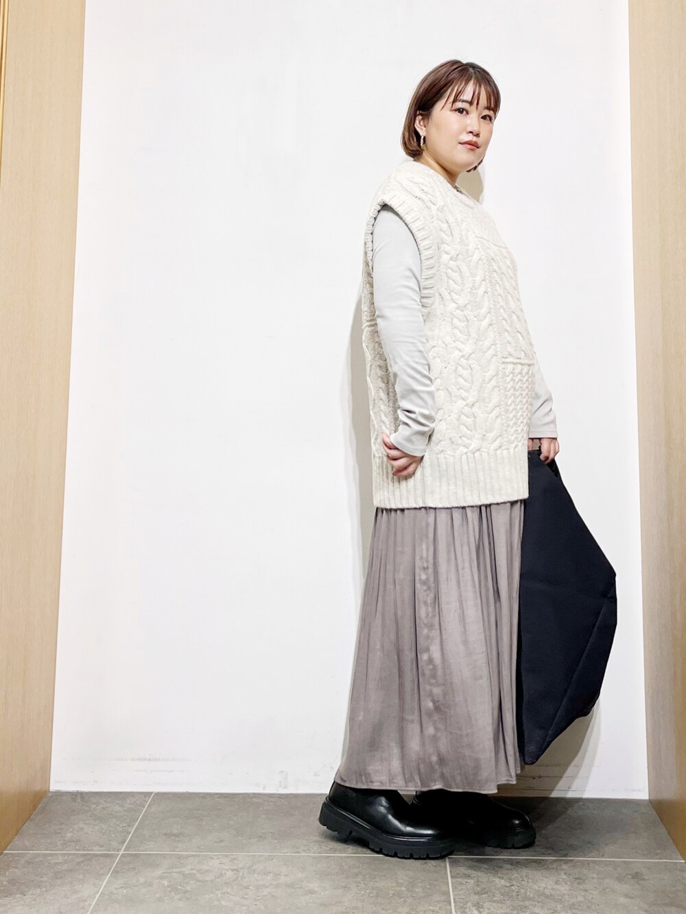 ホワイト系のニット/セーター、ブラック系のトートバッグ、グレー系のその他パンツを着用したレディースの秋コーディネートの4枚目の写真