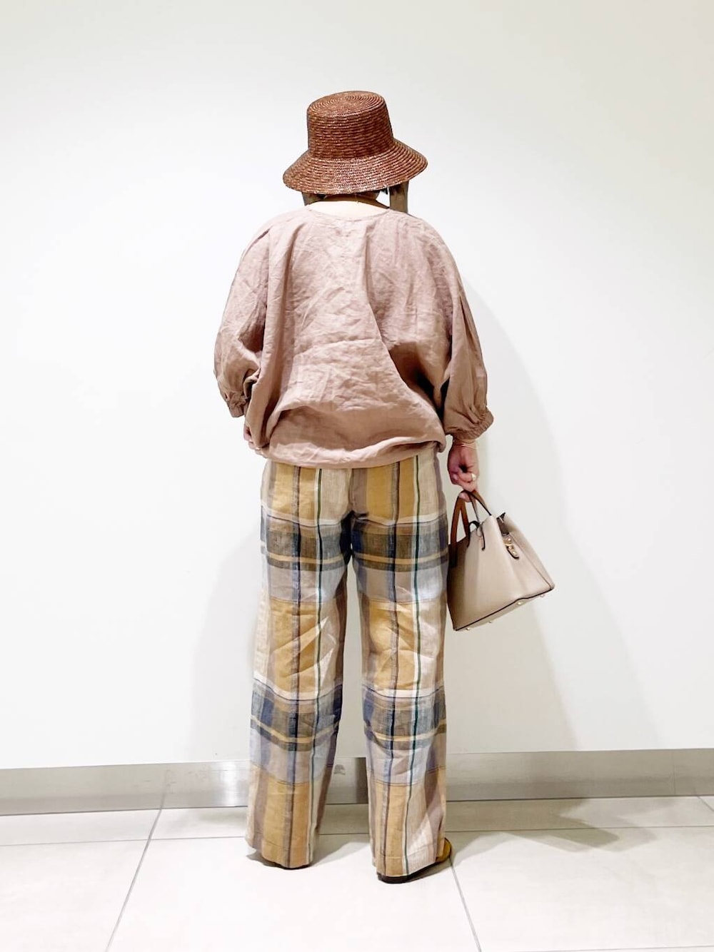 ベージュ系のハンドバッグ、イエロー系のその他パンツ、イエロー系のサンダルを着用したレディースの春コーディネートの6枚目の写真