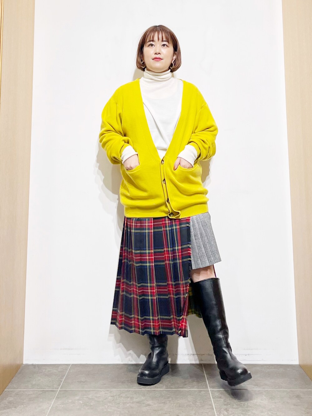 イエロー系のカーディガン/ボレロ、ホワイト系のニット/セーター、その他のスカートを着用したレディースの冬コーディネートの5枚目の写真