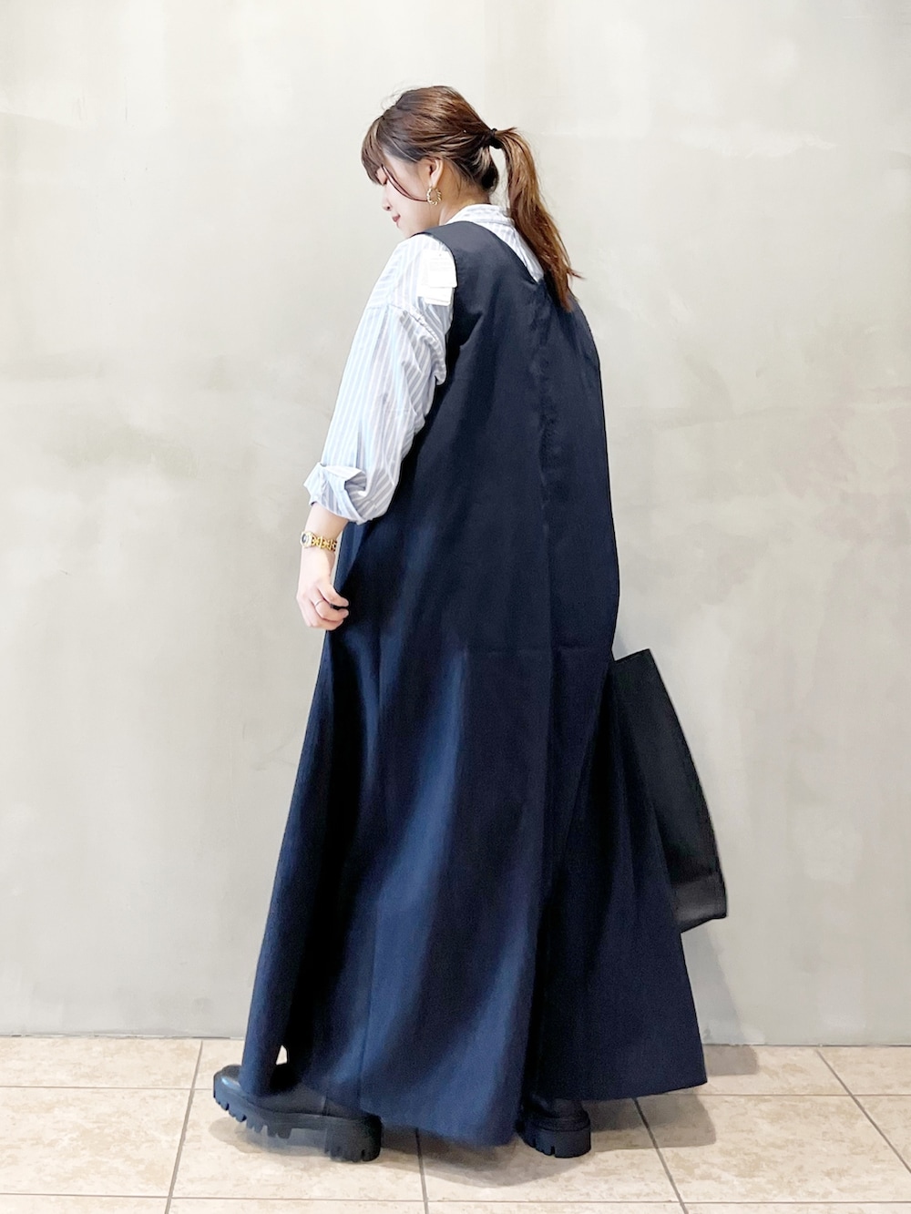 ブルー系のワンピース、ブルー系のシャツ/ブラウス、ブラック系のトートバッグを着用したレディースの秋コーディネートの5枚目の写真