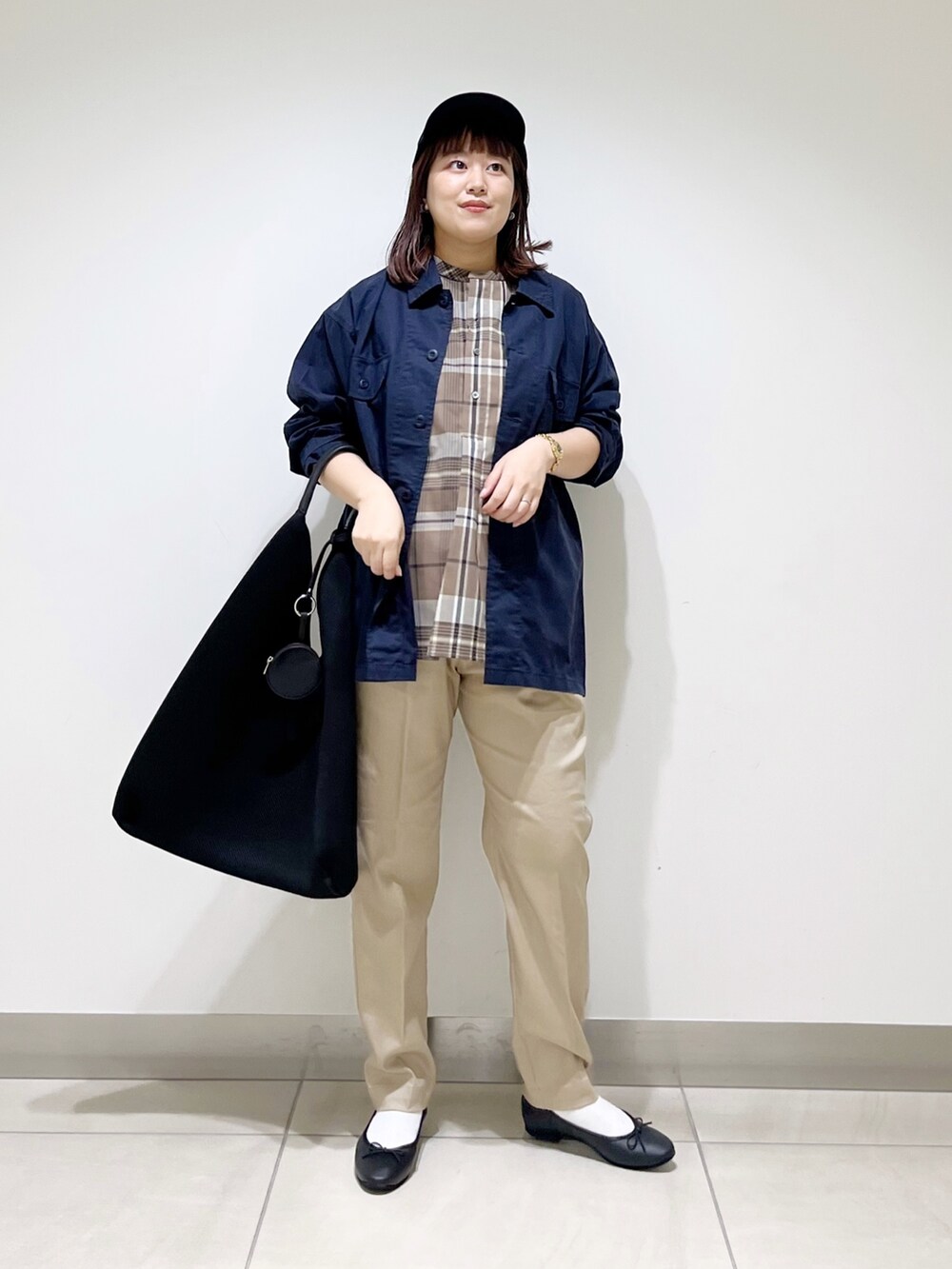 ベージュ系のシャツ/ブラウス、ブルー系のその他アウター、ブラック系のトートバッグを着用したレディースの秋コーディネートの5枚目の写真