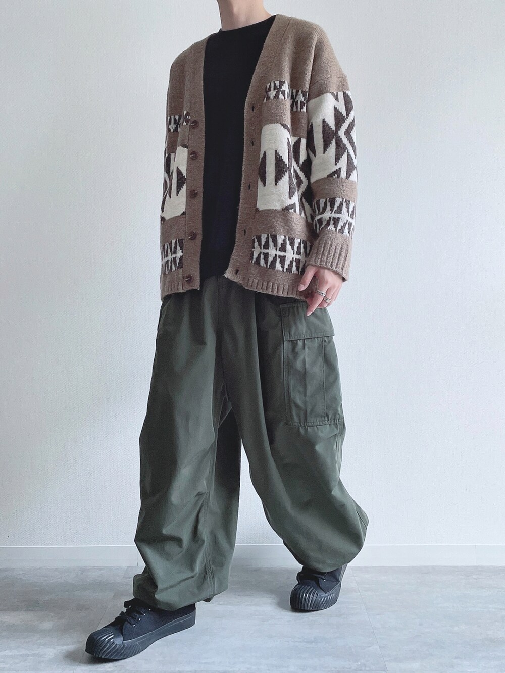 ベージュ系のカーディガン/ボレロ、ブラック系のスウェット、グリーン系のカーゴパンツを着用したメンズの冬コーディネートの5枚目の写真