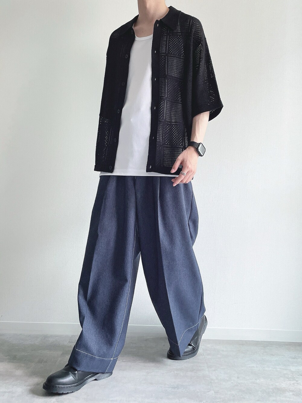 ブラック系のトップス、ホワイト系のタンクトップ、ブルー系のデニムパンツを着用したメンズの夏コーディネートの5枚目の写真