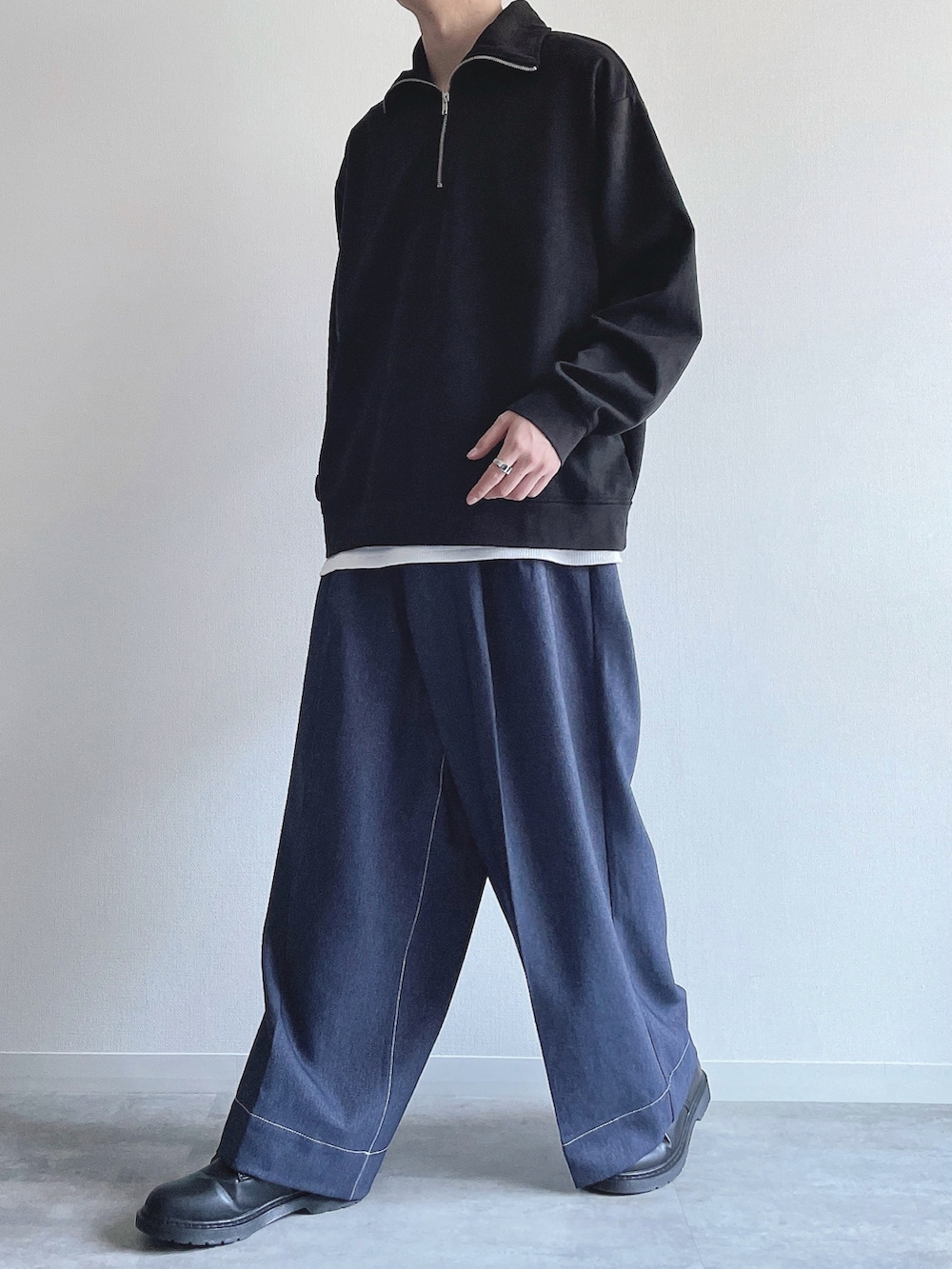 ブラック系のスウェット、ホワイト系のタンクトップ、ブルー系のデニムパンツを着用したメンズの春コーディネートの5枚目の写真