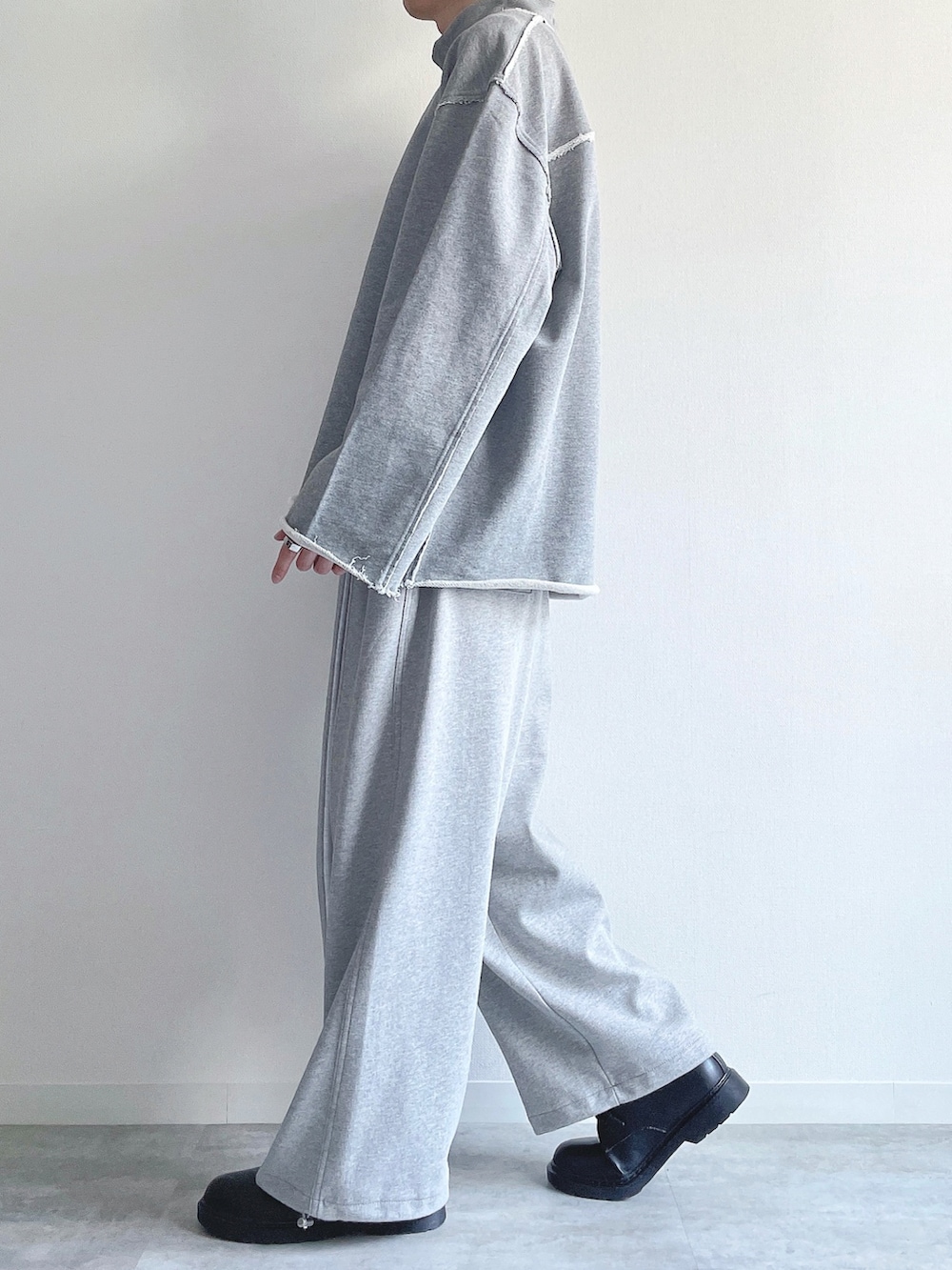 グレー系のスウェット、ホワイト系のTシャツ/カットソー、グレー系のパンツを着用したメンズの冬コーディネートの3枚目の写真