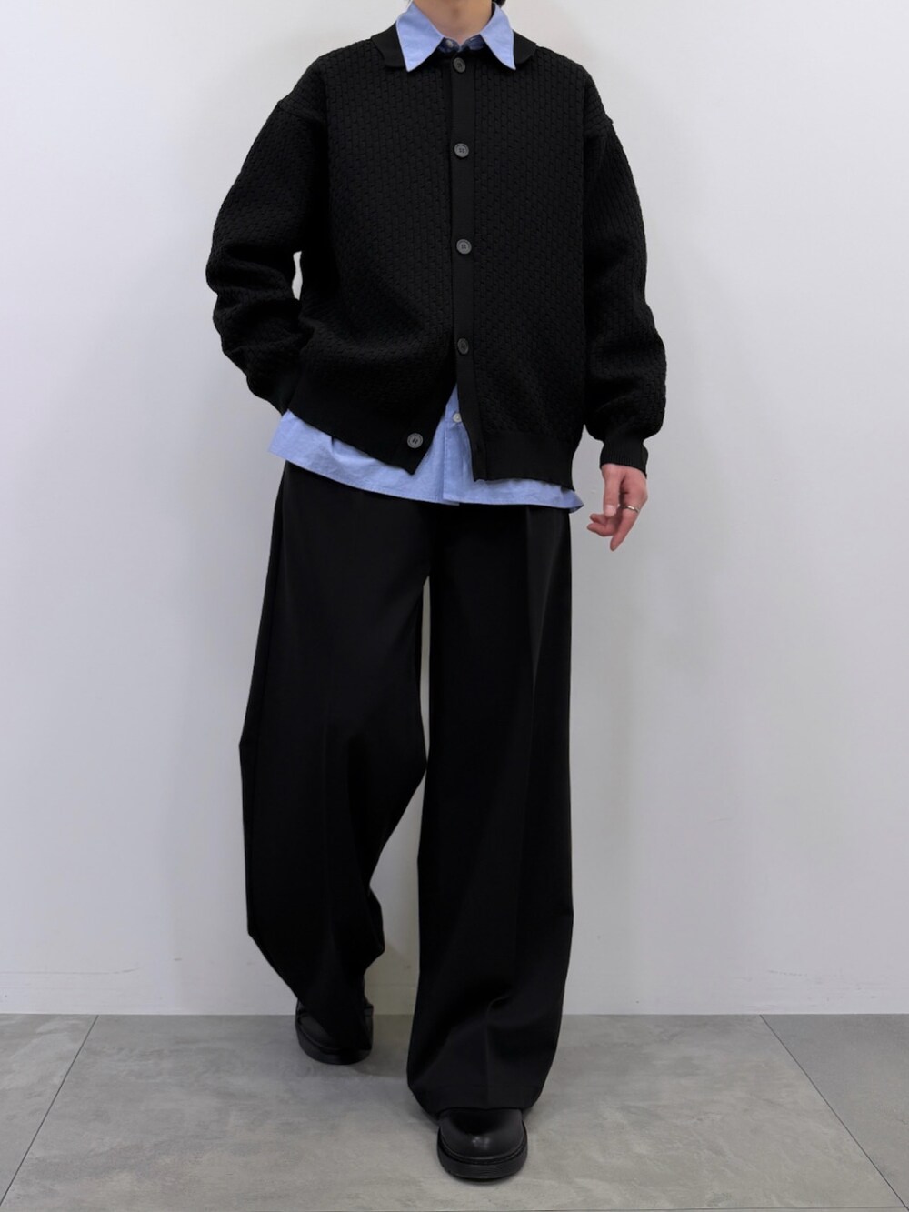 ブラック系のカーディガン/ボレロ、ブルー系のシャツ/ブラウス、ブラック系のスラックスを着用したメンズの春コーディネートの2枚目の写真