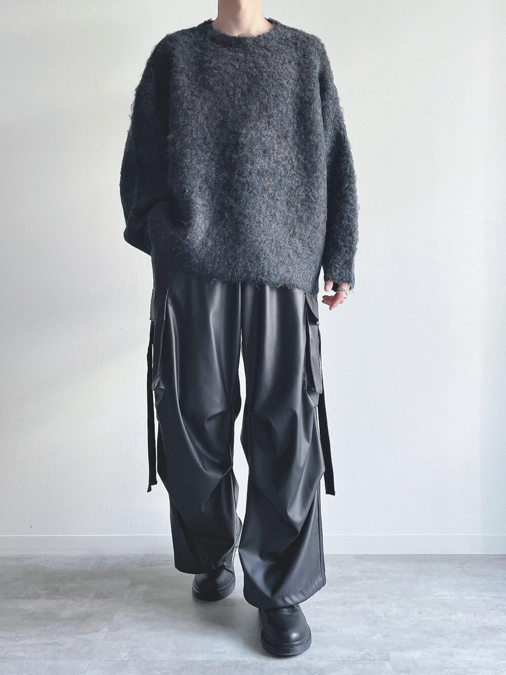 ブルー系のニット/セーター、ブラック系のカーゴパンツ、ブラック系のシューズを着用したメンズの冬コーディネートの2枚目の写真