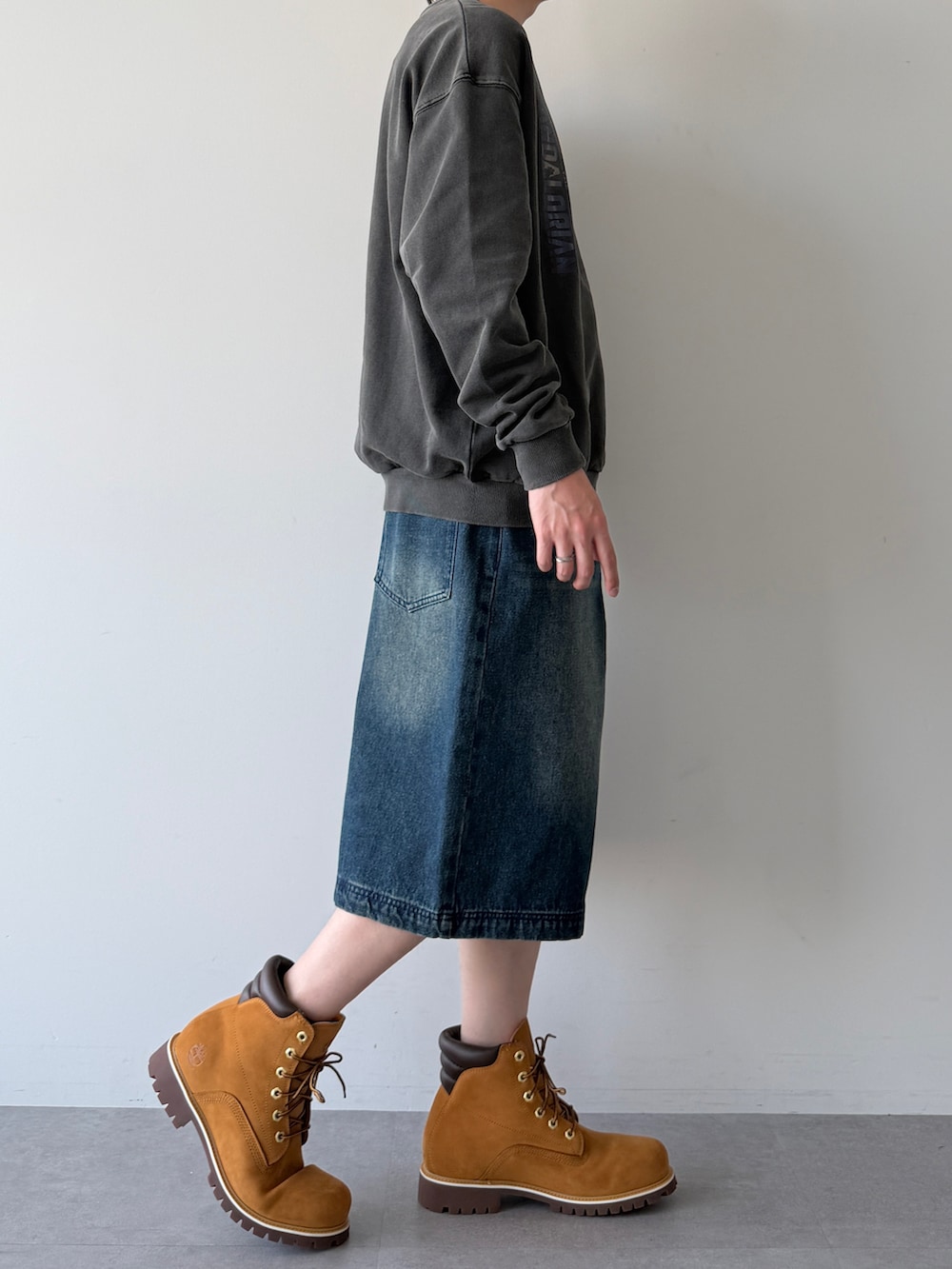 ブラック系のスウェット、ブルー系のその他パンツ、ブラウン系のブーツを着用したメンズの春コーディネートの3枚目の写真