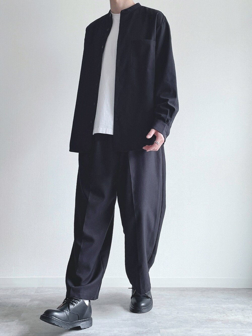 ブラック系のトップス、ホワイト系のTシャツ/カットソー、ブラック系のスラックスを着用したメンズの春コーディネートの5枚目の写真